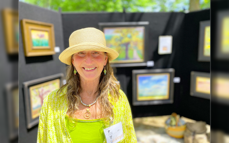 Julie Wiegand with her work on display.