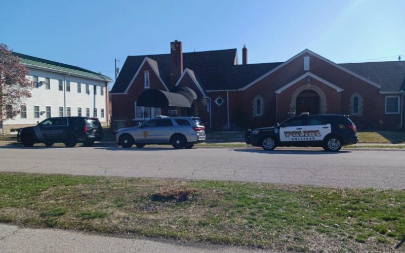 photograph of police vehicles in front of a funeral home
