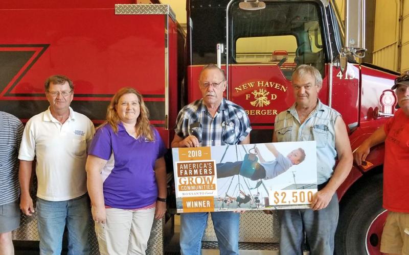 A donation to the New Haven-Berger Fire District was presented recently to the district board. From left to right are directors Wendy Krull, Norbert Horstmann, Sharon Wilson and Harold Englert, farmer Wayne Carl and director Kirby Menke.
