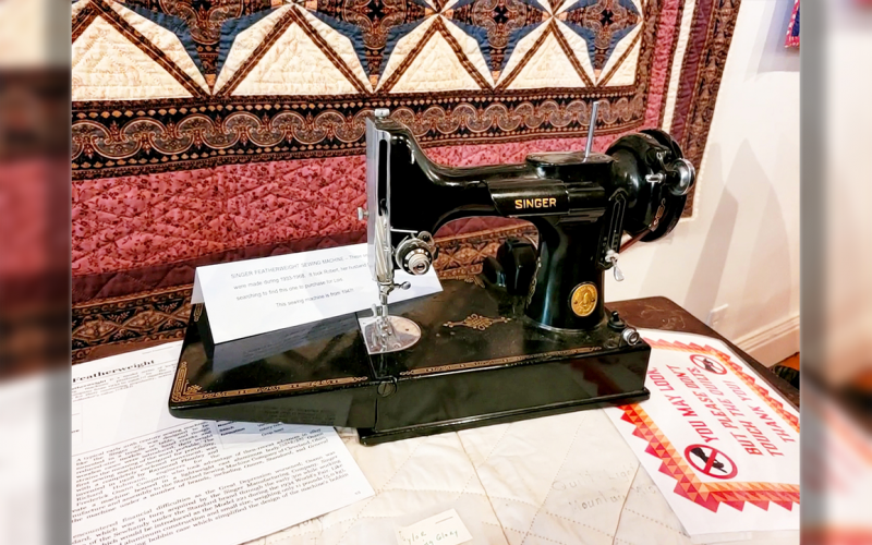 A 1947 SINGER FEATHERWEIGHT SEWING MACHINE, owned by the talented Lois Mueller.