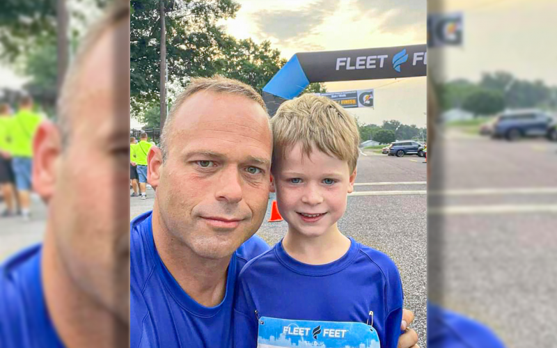 ZACH AND JACKSON ZUROWESTE at the finish line. Five year old Jackson ran the 5K with dad in tow cheering him on.