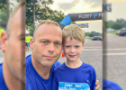 ZACH AND JACKSON ZUROWESTE at the finish line. Five year old Jackson ran the 5K with dad in tow cheering him on.