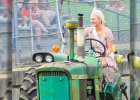 ABIGAIL TOBBEN, 2021 Fair Queen, drives a tractor around the tractor pull area just before the main pulling events.